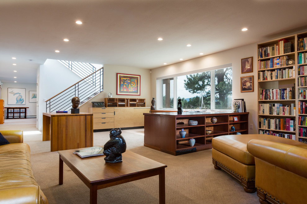 Expansive contemporary home office in Denver with a library, white walls, carpet, no fireplace, a freestanding desk and beige floor.