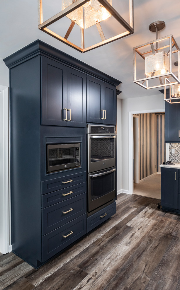 Photo of a small modern galley separate kitchen in Atlanta with an undermount sink, shaker cabinets, blue cabinets, quartz benchtops, multi-coloured splashback, porcelain splashback, coloured appliances, vinyl floors, no island, multi-coloured floor and grey benchtop.