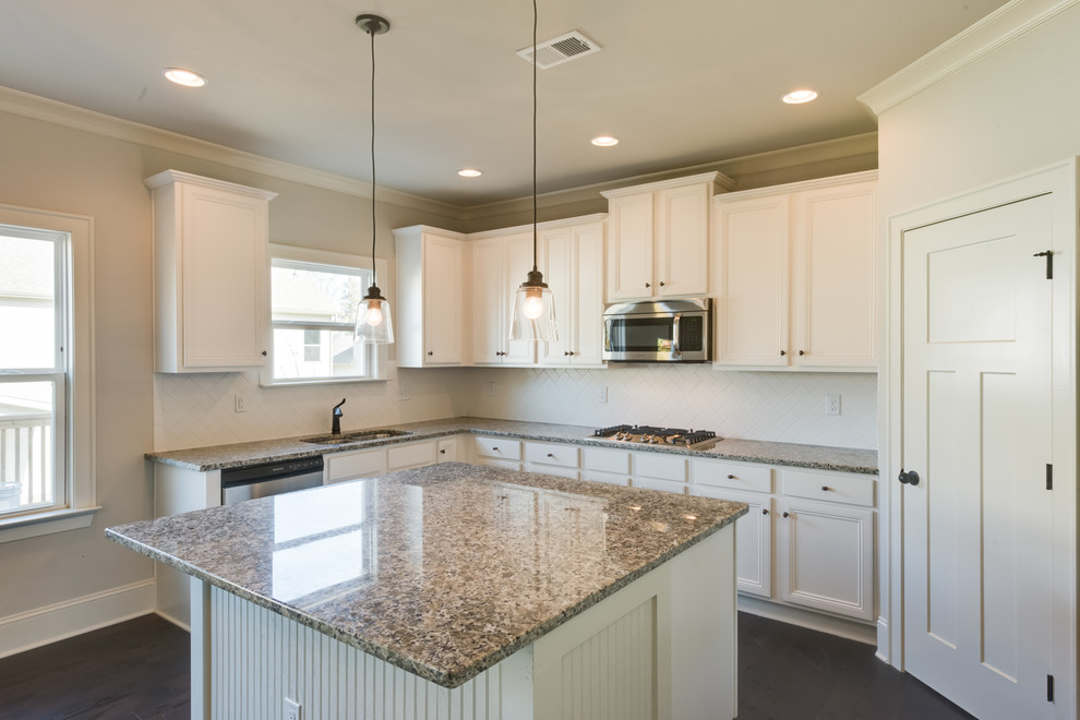 Inspiration for a large transitional u-shaped dark wood floor and brown floor eat-in kitchen remodel with an undermount sink, recessed-panel cabinets, white cabinets, granite countertops, white backsplash, subway tile backsplash, stainless steel appliances and an island