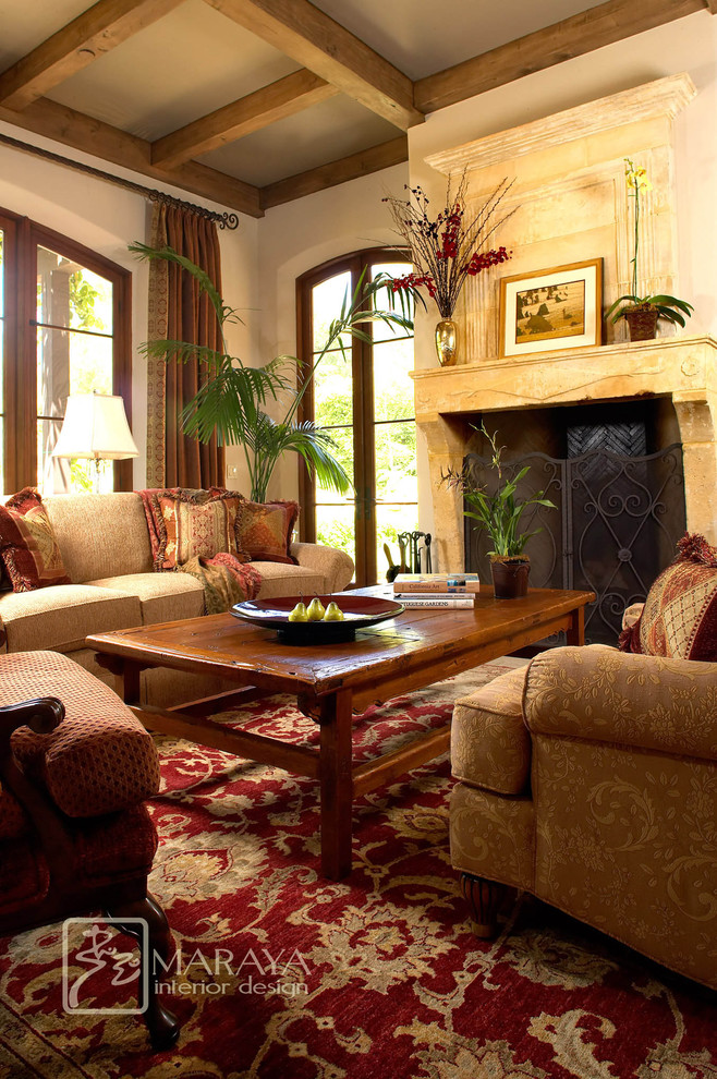 Example of a large tuscan formal and open concept limestone floor living room design in Santa Barbara with white walls, a standard fireplace, a stone fireplace and no tv