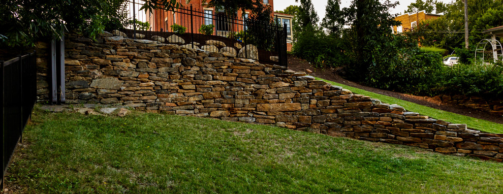 Backyard stone and rectangular hot tub photo