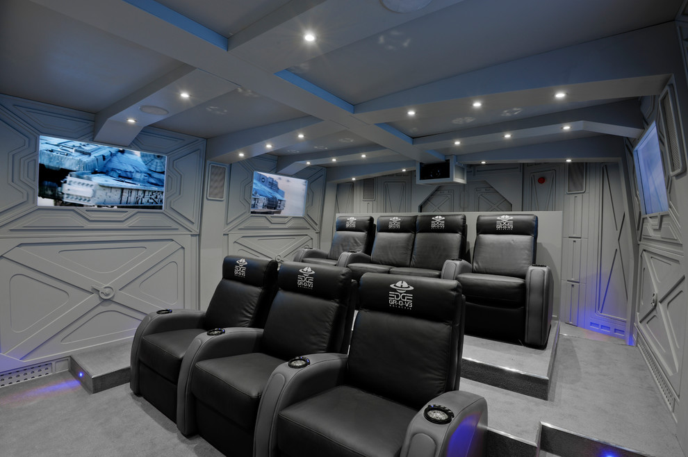 Photo of a large industrial enclosed home theatre in Hertfordshire with grey walls, carpet and grey floor.