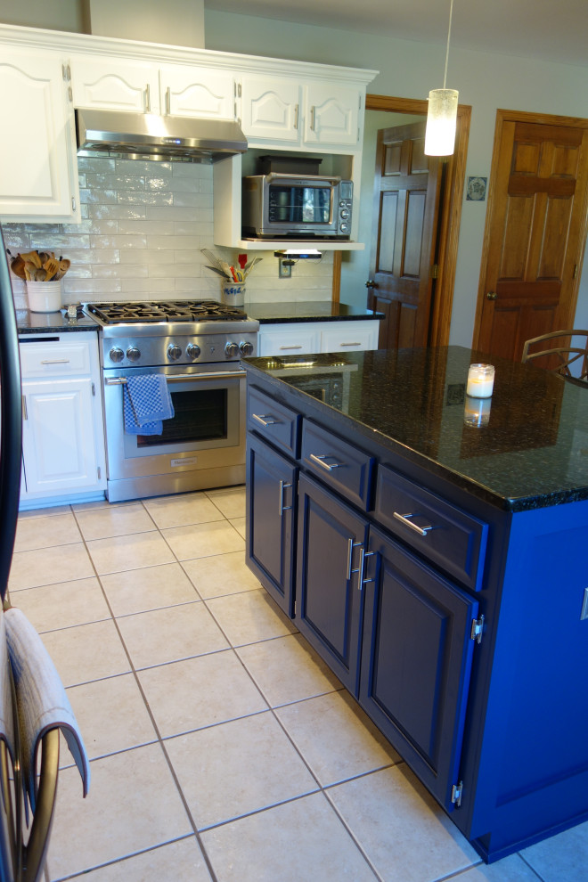 Inspiration for a transitional kitchen remodel in Milwaukee with granite countertops, gray backsplash, ceramic backsplash and an island
