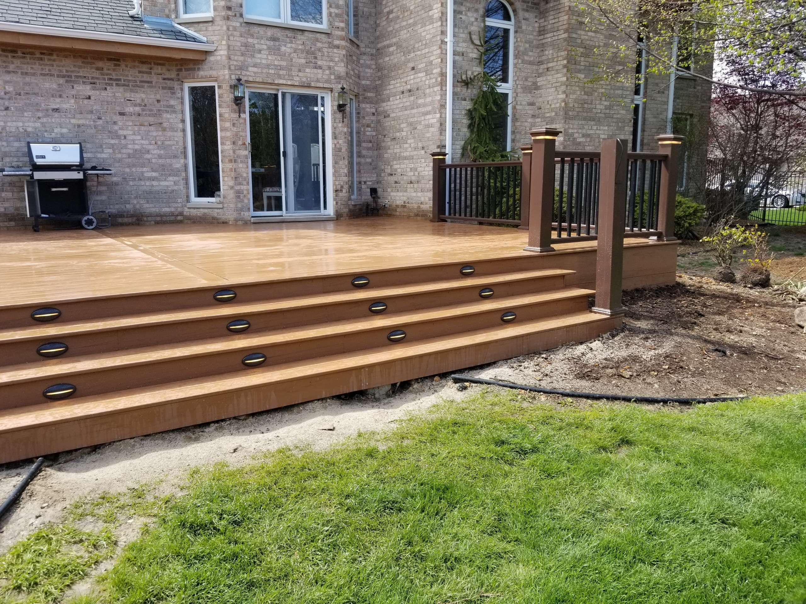 Composite deck with composite railing and lighting
