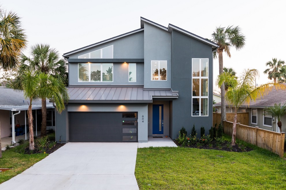 Inspiration for a mid-sized contemporary two-storey stucco grey house exterior in Jacksonville with a gable roof and a mixed roof.