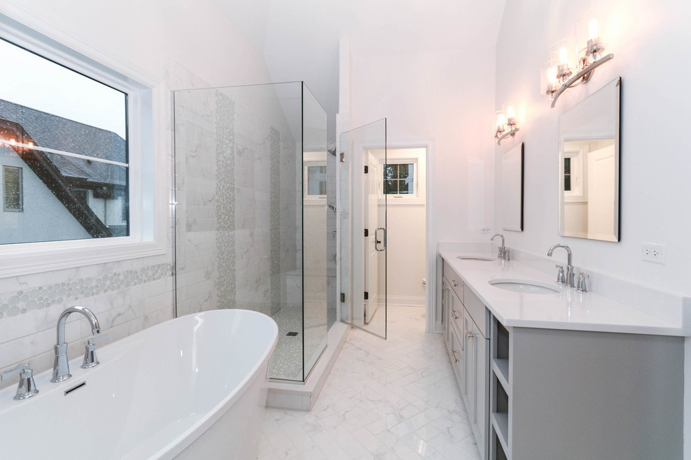 Photo of a large arts and crafts master wet room bathroom in Chicago with shaker cabinets, grey cabinets, a freestanding tub, white tile, subway tile, white walls, mosaic tile floors, an undermount sink, engineered quartz benchtops, white floor, a hinged shower door and white benchtops.