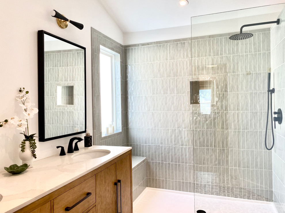 Photo of a mid-sized contemporary master bathroom in St Louis with flat-panel cabinets, light wood cabinets, white tile, engineered quartz benchtops, white benchtops, a double vanity, a freestanding vanity and vaulted.