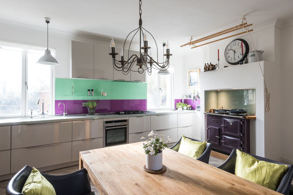 This is an example of a transitional kitchen in Surrey with coloured appliances.