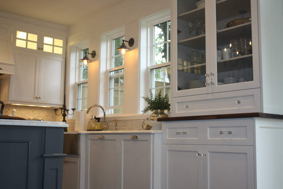 Kitchen - mid-sized transitional l-shaped kitchen idea with shaker cabinets, white cabinets, white backsplash, stainless steel appliances, an island, a double-bowl sink and mosaic tile backsplash