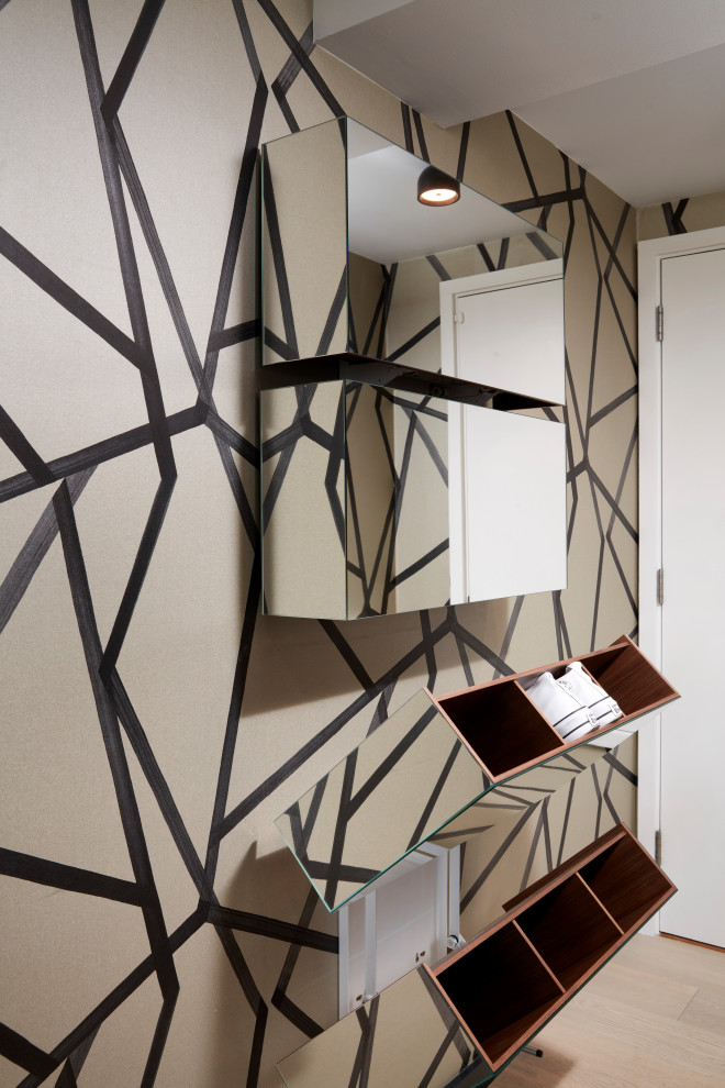 Photo of a small contemporary entry hall in London with black walls and wallpaper.
