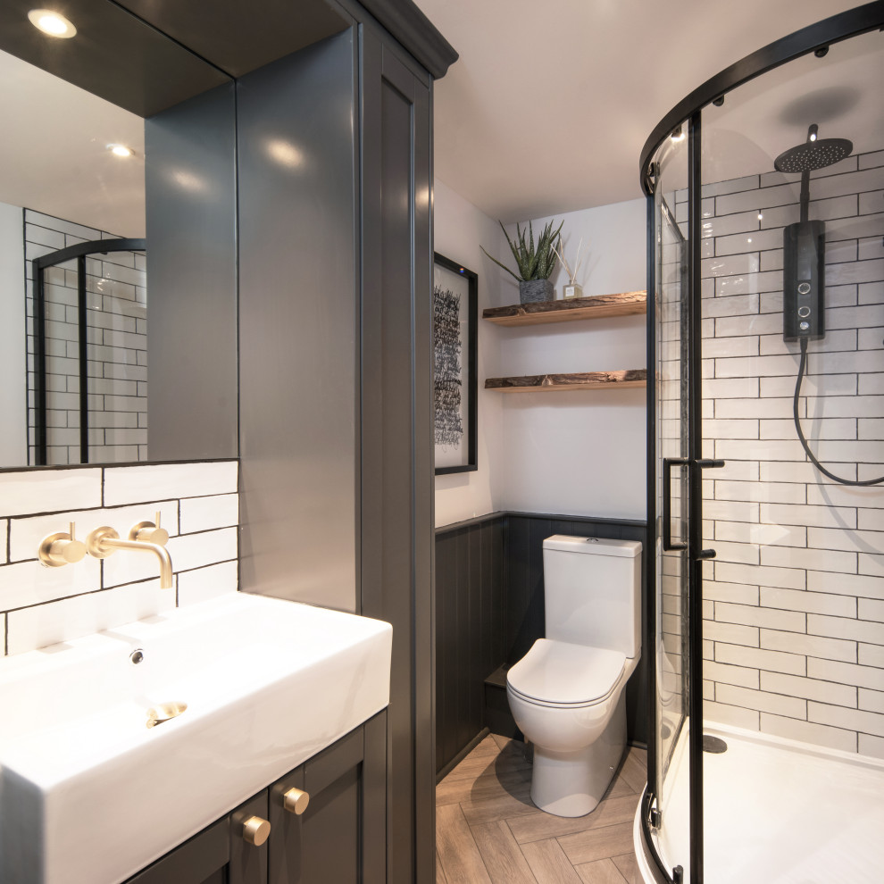 Bathroom - mid-sized coastal kids' white tile and ceramic tile laminate floor, brown floor, single-sink and shiplap wall bathroom idea in Other with shaker cabinets, black cabinets, a one-piece toilet, white walls, a drop-in sink, solid surface countertops and a built-in vanity