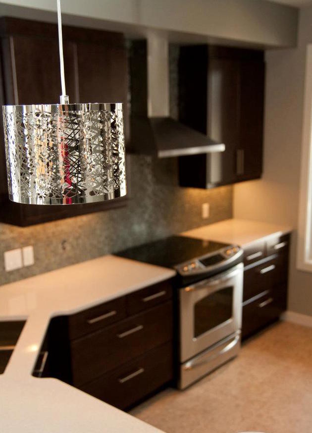 Inspiration for a mid-sized transitional l-shaped dark wood floor eat-in kitchen remodel with a double-bowl sink, shaker cabinets, dark wood cabinets, metallic backsplash, stainless steel appliances and a peninsula
