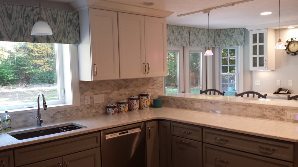Example of a transitional u-shaped medium tone wood floor kitchen design in Boston with an undermount sink, white cabinets, quartz countertops, multicolored backsplash and a peninsula