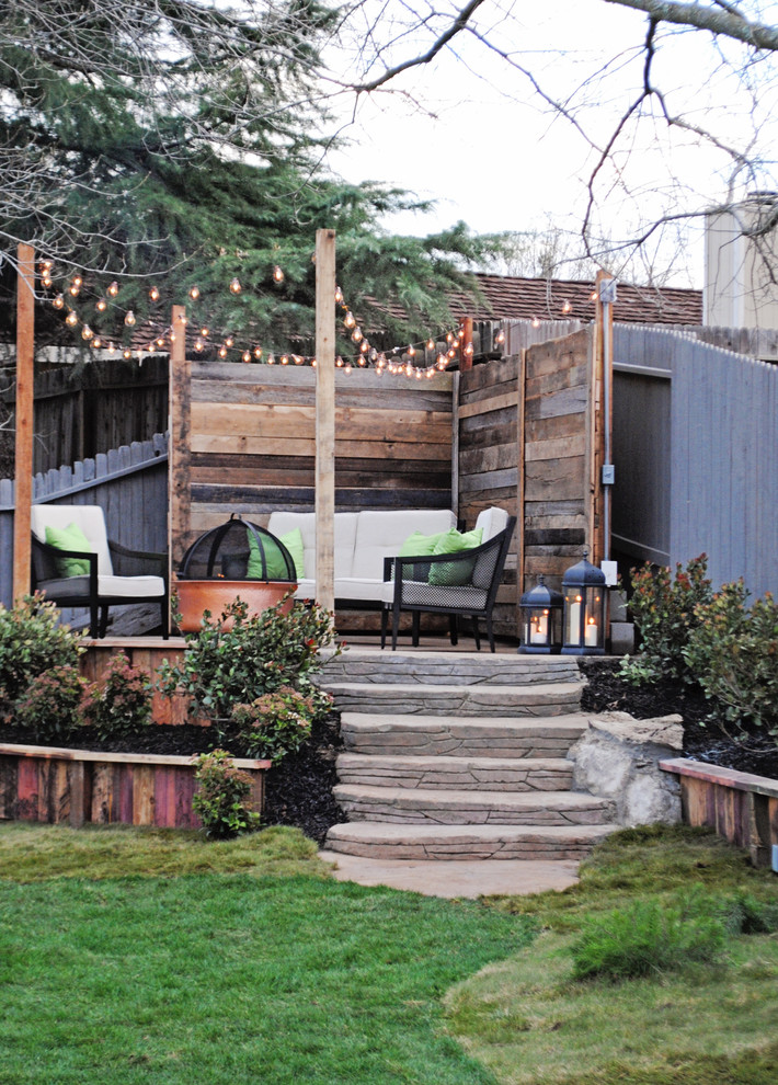This is an example of a mid-sized transitional backyard patio in Sacramento with a fire feature.