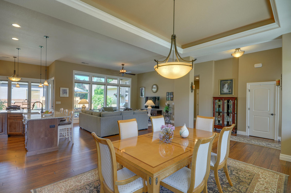 Photo of a large arts and crafts open plan dining in Portland with beige walls, medium hardwood floors and no fireplace.