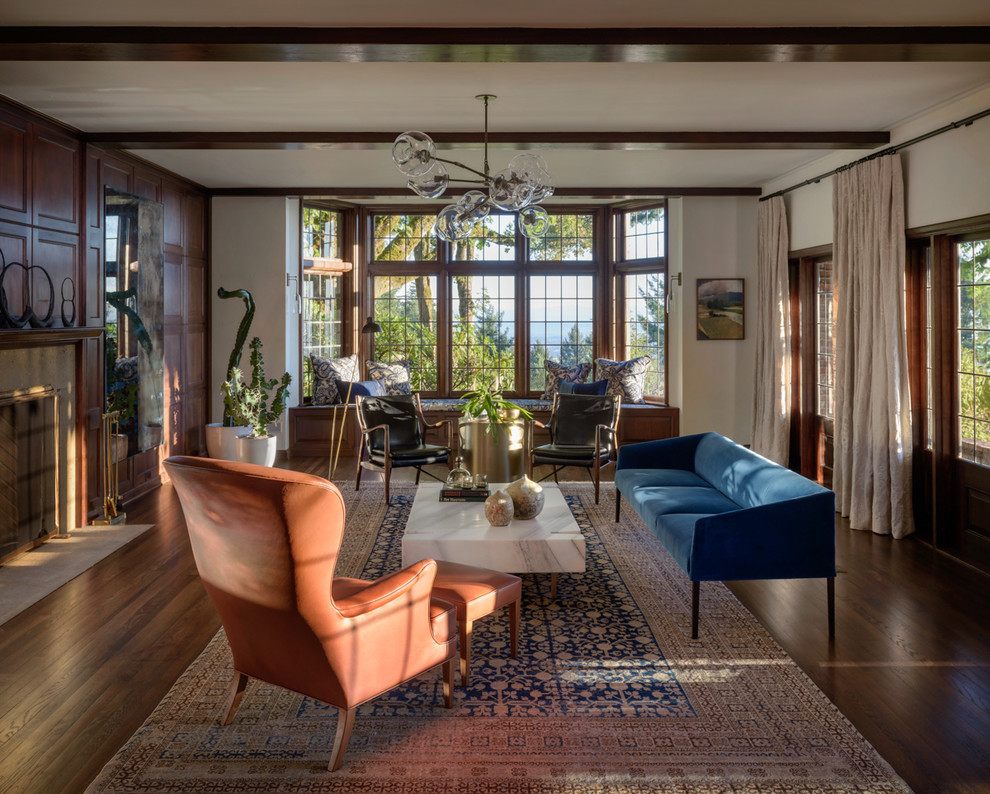 Traditional living room in Portland with white walls, dark hardwood floors, a standard fireplace and brown floor.
