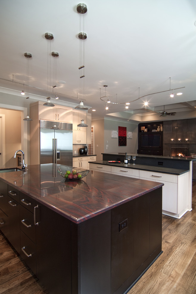 Inspiration for a contemporary open plan kitchen in Charlotte with stainless steel appliances and red benchtop.