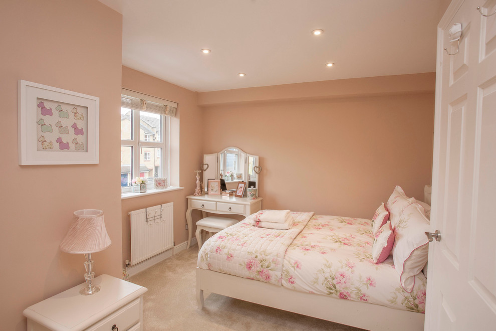 Design ideas for a mid-sized traditional kids' bedroom for kids 4-10 years old and girls in London with pink walls, carpet and beige floor.