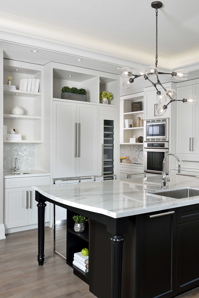 Inspiration for a mid-sized transitional l-shaped open plan kitchen in Toronto with shaker cabinets, white splashback, medium hardwood floors, with island, a single-bowl sink, marble benchtops, stone slab splashback and panelled appliances.
