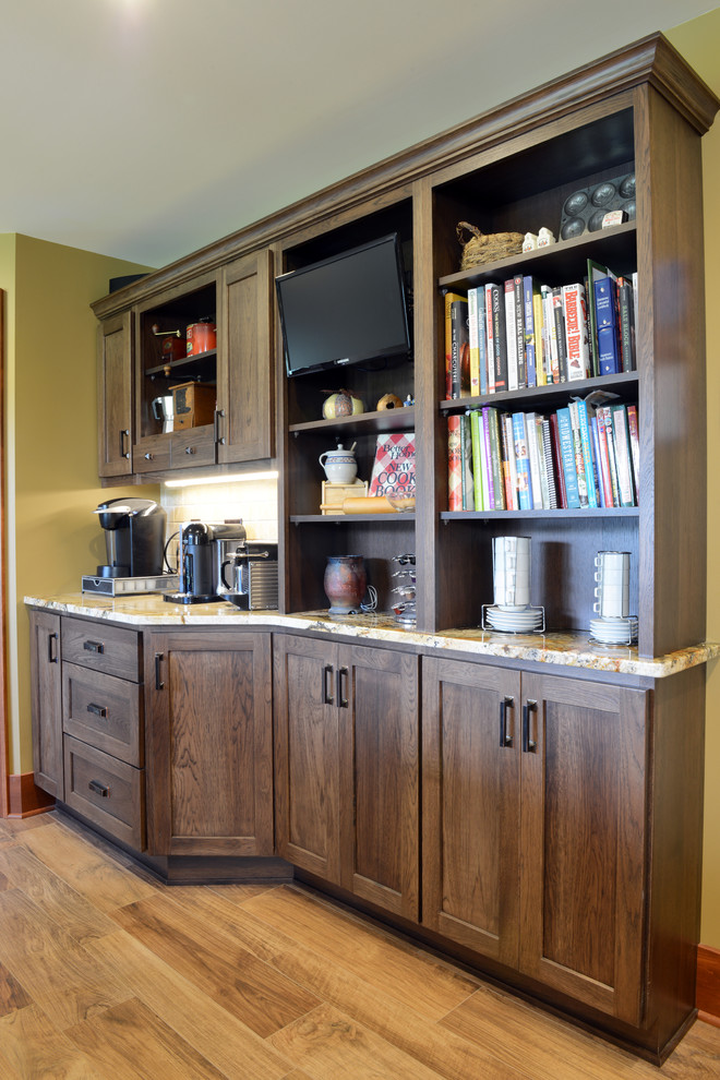 Example of a large classic galley eat-in kitchen design with a farmhouse sink, shaker cabinets, granite countertops, stainless steel appliances and an island