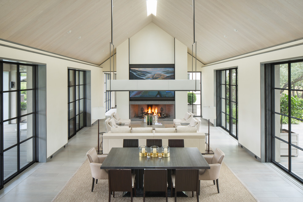 This is an example of a country formal open concept living room in San Francisco with white walls, a ribbon fireplace and beige floor.