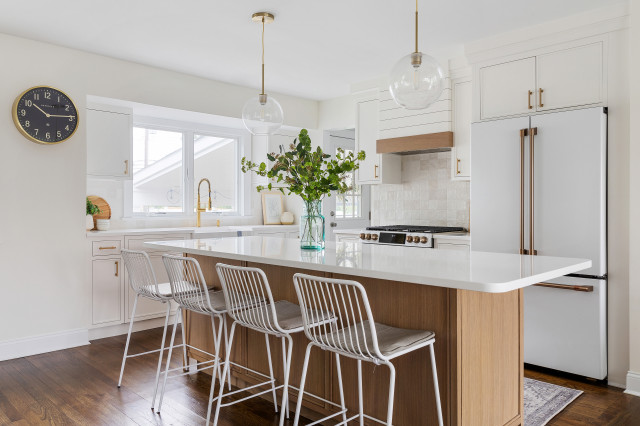 This modern farmhouse-style family home's kitchen features Emtek's