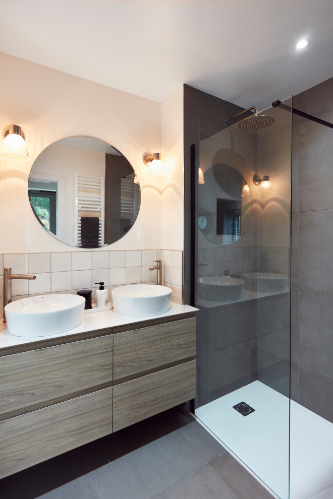 Inspiration for a small master bathroom in Other with flat-panel cabinets, light wood cabinets, an open shower, gray tile, ceramic tile, grey walls, ceramic floors, a wall-mount sink, marble benchtops, grey floor, an open shower, white benchtops, a double vanity and a built-in vanity.