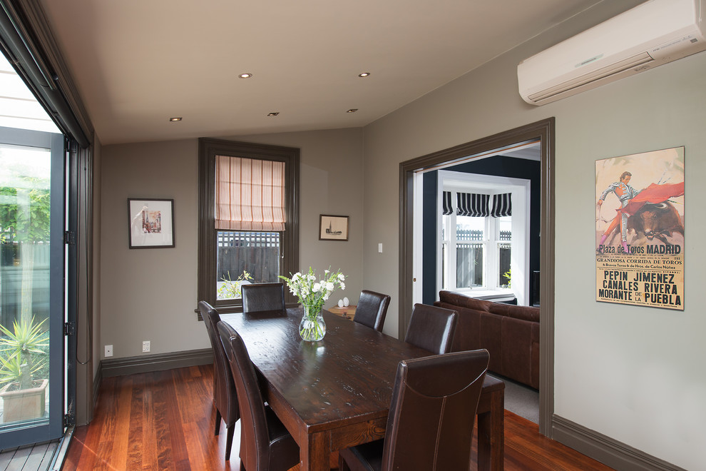Contemporary separate dining room in Christchurch with grey walls and medium hardwood floors.