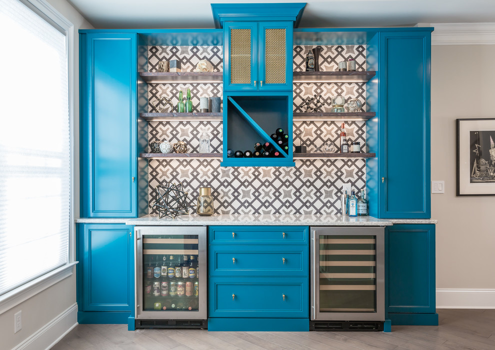 Design ideas for a mid-sized traditional single-wall home bar in Raleigh with blue cabinets, quartz benchtops, multi-coloured splashback, cement tile splashback, beaded inset cabinets and medium hardwood floors.