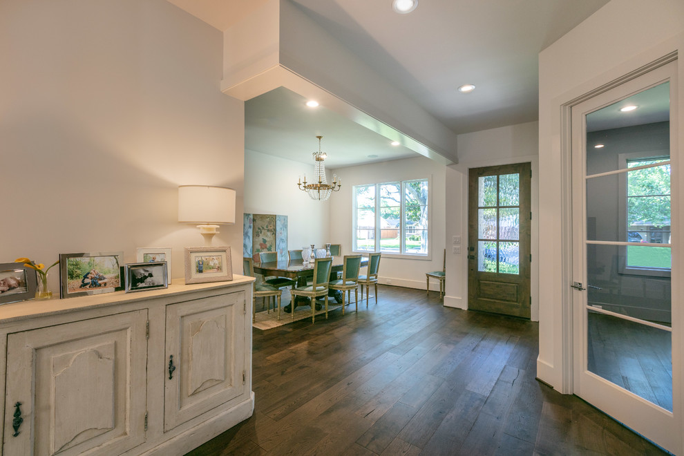 Large transitional entry hall in Houston with white walls, dark hardwood floors, a single front door, a brown front door and brown floor.