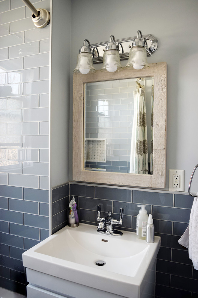 This is an example of a 3/4 bathroom in Boston with blue tile, glass tile and a shower curtain.