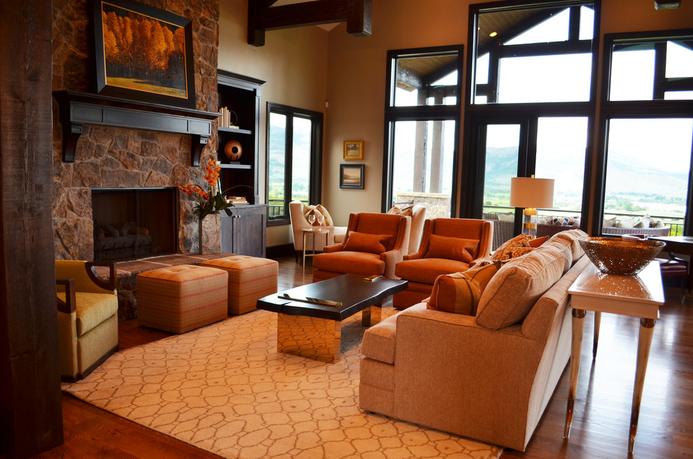 This is an example of a large transitional formal open concept living room in Salt Lake City with beige walls, a ribbon fireplace, a stone fireplace surround, no tv, dark hardwood floors and brown floor.