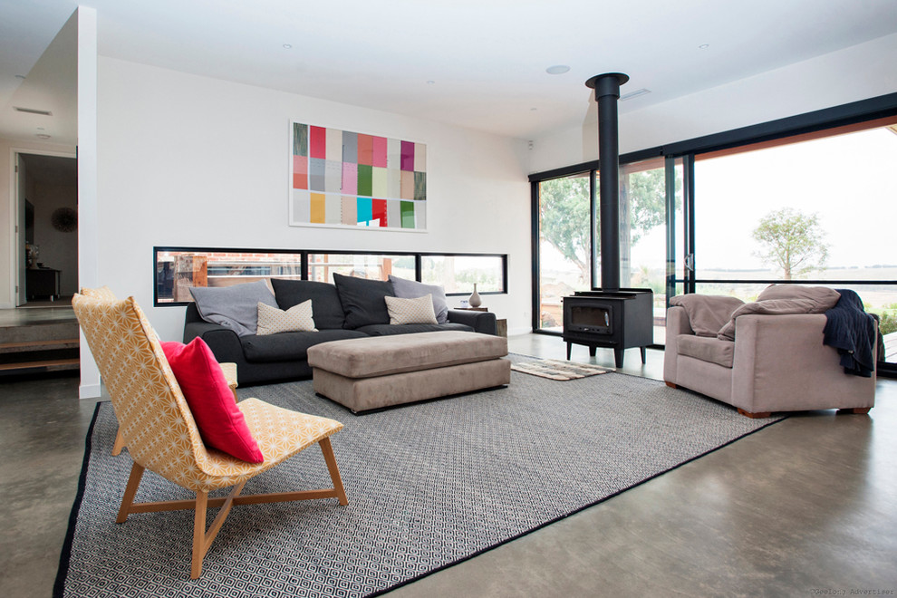 Contemporary formal open concept living room in Melbourne with white walls, concrete floors, a standard fireplace and no tv.