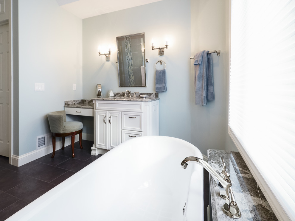 Design ideas for a large traditional master bathroom in Minneapolis with an undermount sink, furniture-like cabinets, white cabinets, engineered quartz benchtops, a claw-foot tub, gray tile, blue tile, multi-coloured tile, blue walls, a corner shower, matchstick tile, slate floors, grey floor and a hinged shower door.
