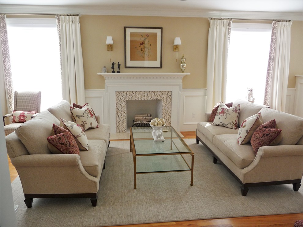 This is an example of a large traditional formal open concept living room in Boston with beige walls, medium hardwood floors, a standard fireplace, a wood fireplace surround and no tv.