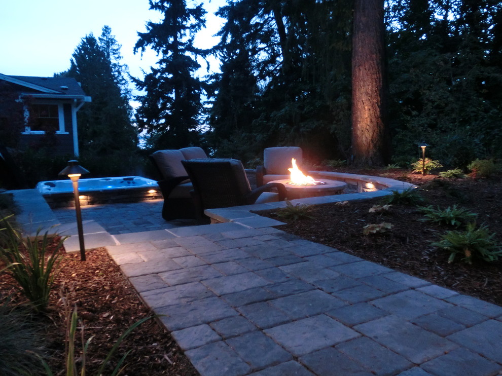 Inspiration for a large contemporary backyard garden in Seattle with a fire feature and concrete pavers.