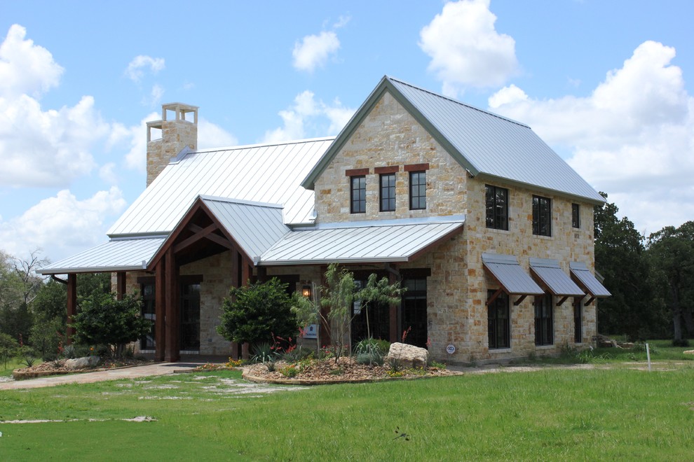 Large transitional beige two-story stone exterior home photo
