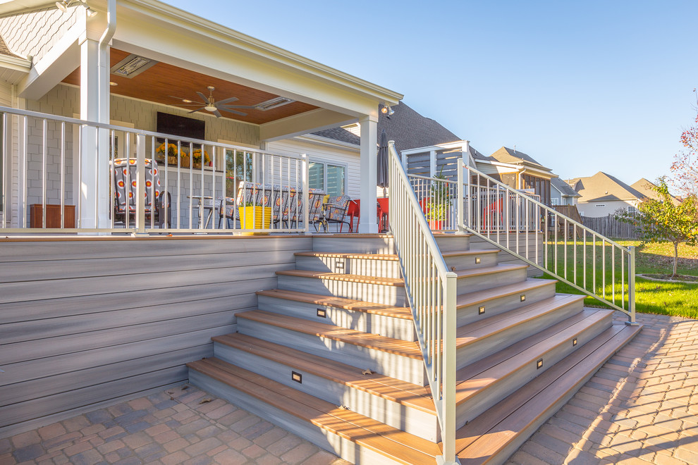 Large transitional backyard deck photo in Nashville with a roof extension