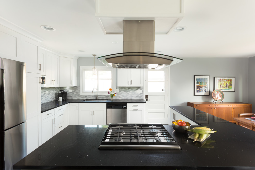 Open concept kitchen - large transitional l-shaped medium tone wood floor open concept kitchen idea in Chicago with an undermount sink, shaker cabinets, white cabinets, granite countertops, multicolored backsplash, ceramic backsplash, stainless steel appliances and no island