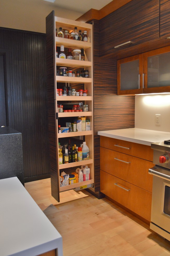 Kitchen - large light wood floor kitchen idea with flat-panel cabinets, dark wood cabinets, quartzite countertops, white backsplash, stone slab backsplash, stainless steel appliances and an island