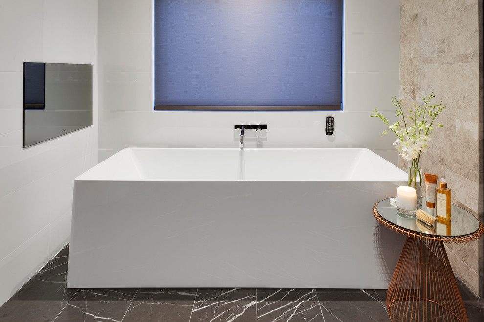 This is an example of a large contemporary master bathroom in Perth with an integrated sink, engineered quartz benchtops, a freestanding tub, an open shower, a one-piece toilet, brown tile, ceramic tile, white walls and marble floors.