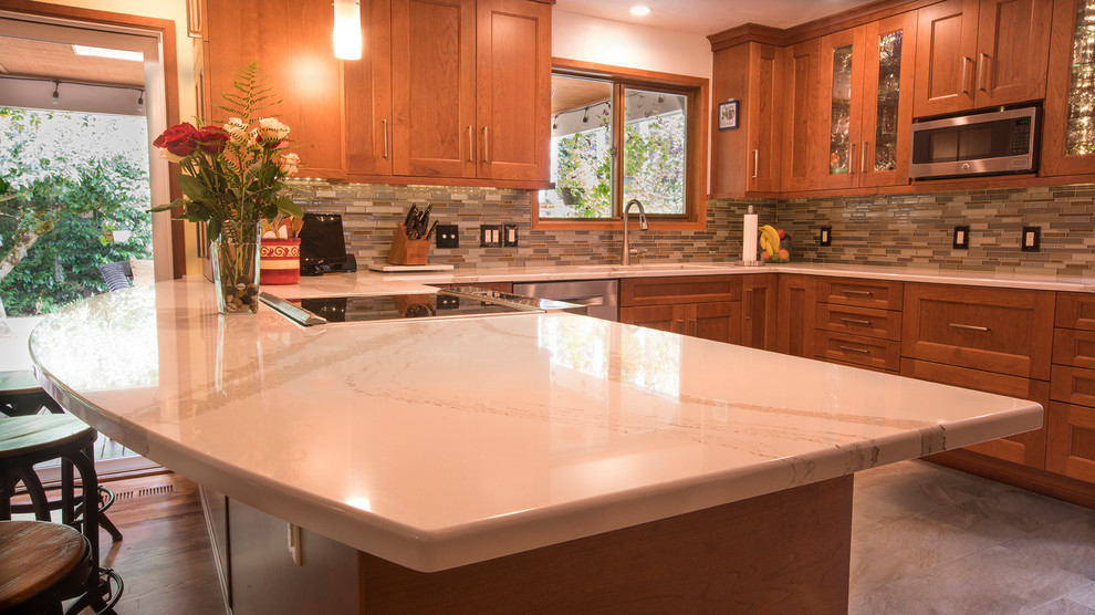 Inspiration for a huge u-shaped porcelain tile and multicolored floor eat-in kitchen remodel in Seattle with an undermount sink, shaker cabinets, medium tone wood cabinets, quartz countertops, multicolored backsplash, mosaic tile backsplash, stainless steel appliances and a peninsula