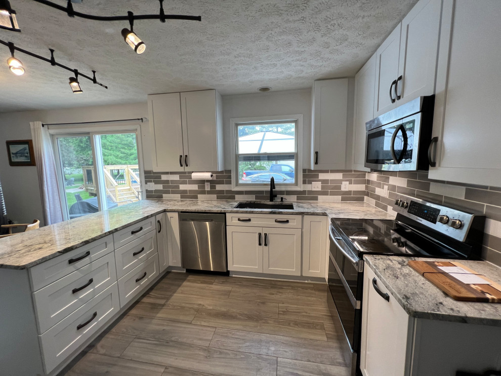 Inspiration for a mid-sized timeless u-shaped eat-in kitchen remodel in Cleveland with shaker cabinets, white cabinets, granite countertops and ceramic backsplash