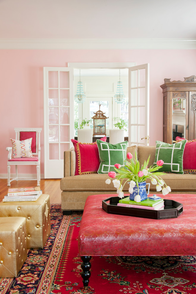 Transitional living room in Other with pink walls.