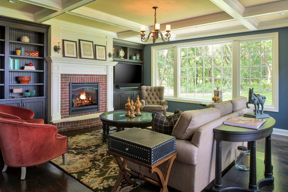 This is an example of a mid-sized traditional open concept family room in Minneapolis with blue walls, dark hardwood floors, a standard fireplace, a brick fireplace surround, a built-in media wall and brown floor.