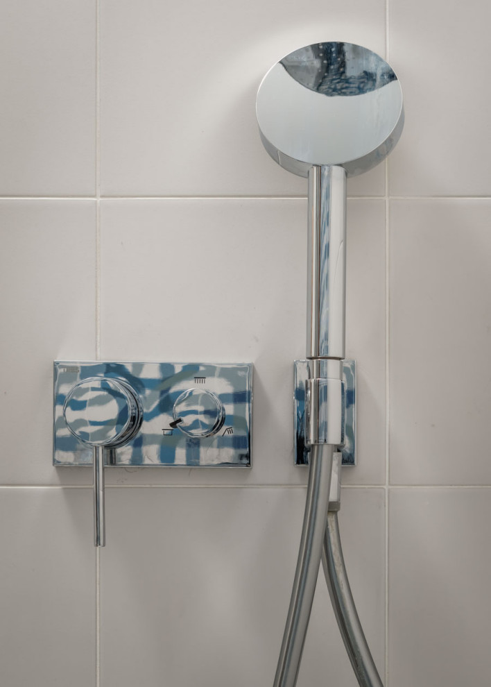 Photo of a small contemporary master bathroom in Barcelona with a drop-in tub, blue tile, cement tile, white walls, ceramic floors, a vessel sink, grey floor, a hinged shower door and an enclosed toilet.