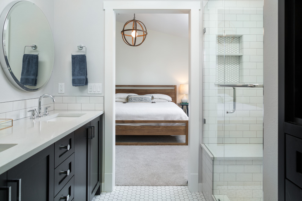 Inspiration for a mid-sized transitional master bathroom in Denver with shaker cabinets, dark wood cabinets, white tile, ceramic tile, grey walls, ceramic floors, an undermount sink and a hinged shower door.