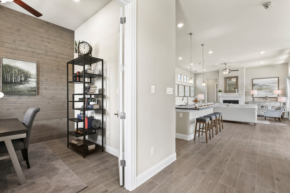 Mid-sized contemporary foyer in Dallas with white walls, light hardwood floors and brown floor.