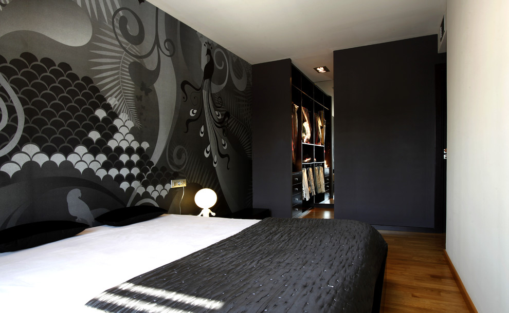 Inspiration for a modern master bedroom in Valencia with black walls, medium hardwood floors and brown floor.