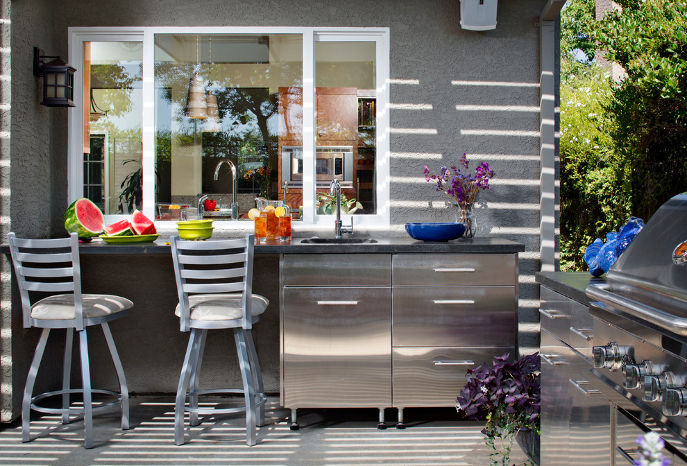 Inspiration for a contemporary backyard patio in Sacramento with an outdoor kitchen, concrete slab and a roof extension.